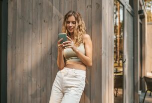 Woman looking at smartphone screen with interest