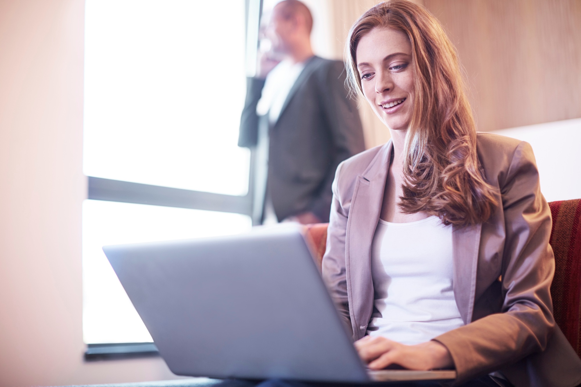 Businesswoman using laptop in hotel room